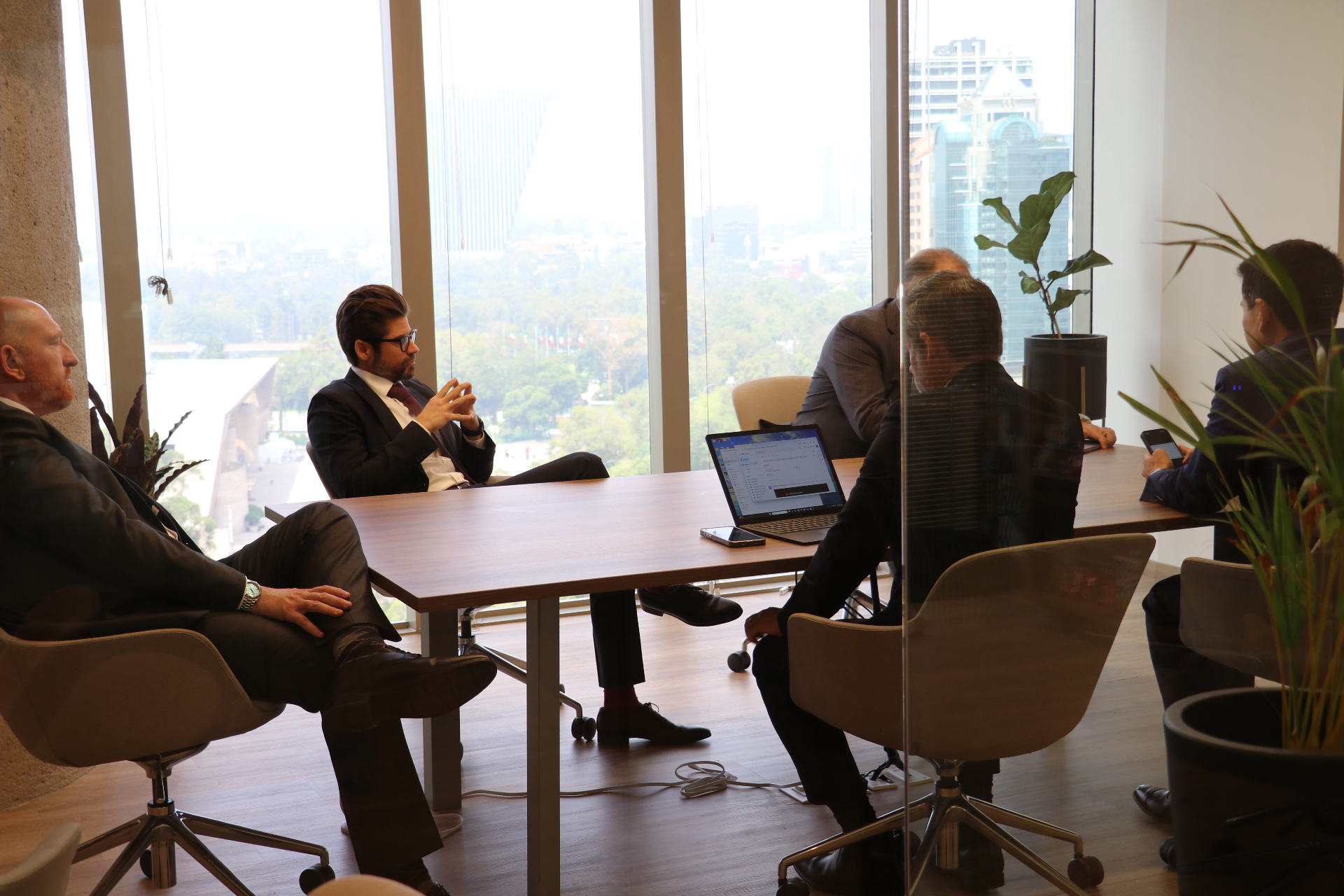 Attorneys meeting in a conference room overlooking a city skyline